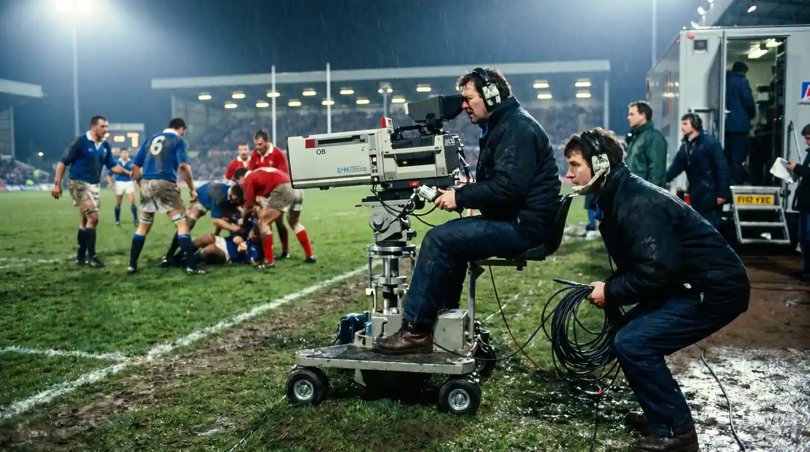 Television camera crew filming a live Premiership rugby broadcast from the touchline