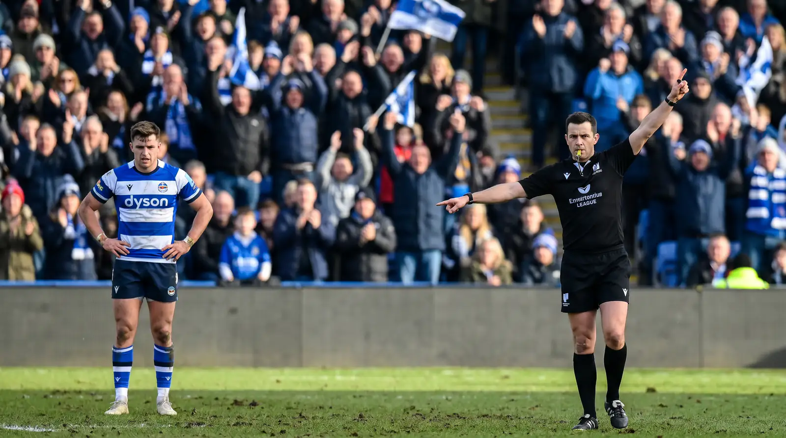 Referee awarding a penalty during a rugby match as the penalty count influences live odds
