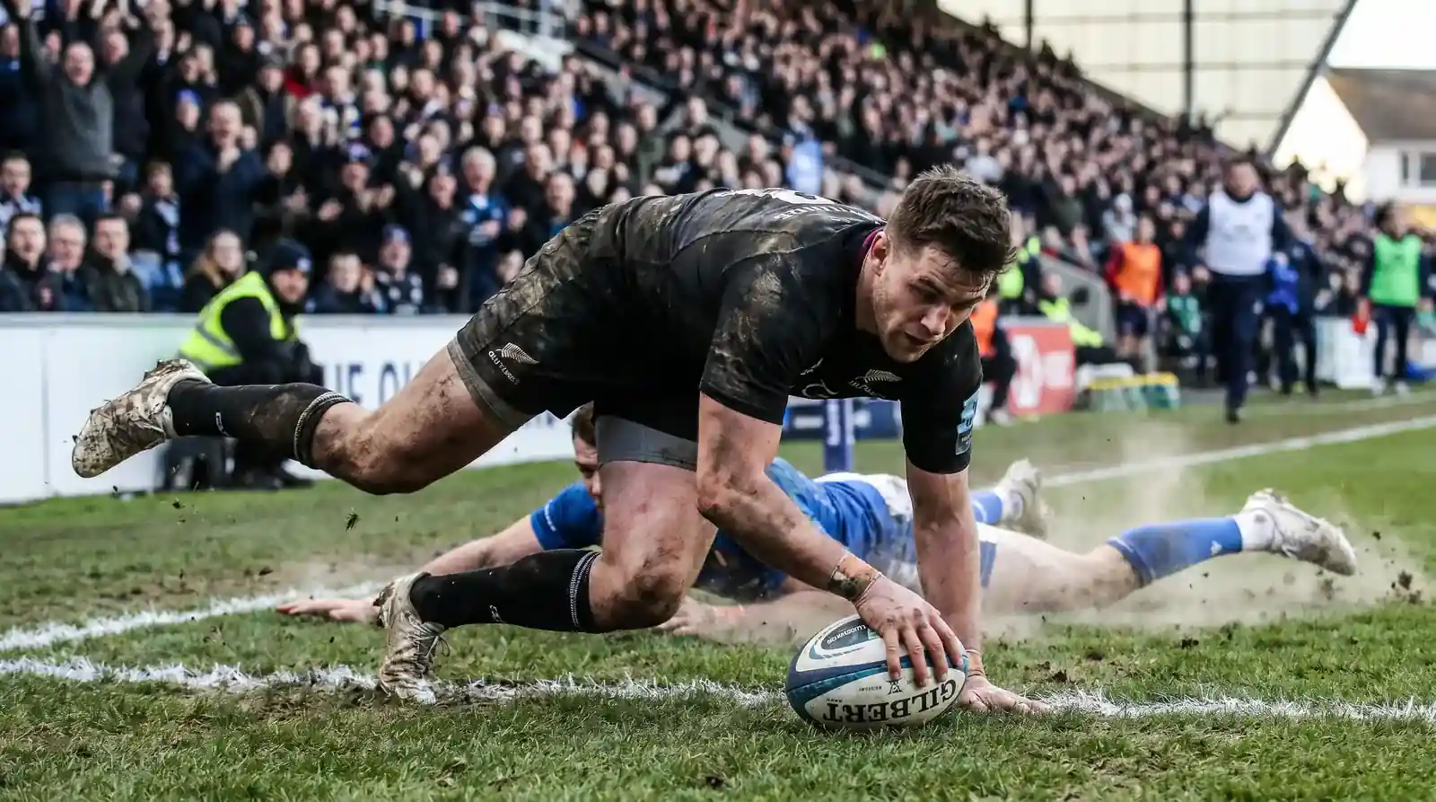 Rugby player grounding the ball over the try line for five points in a union match