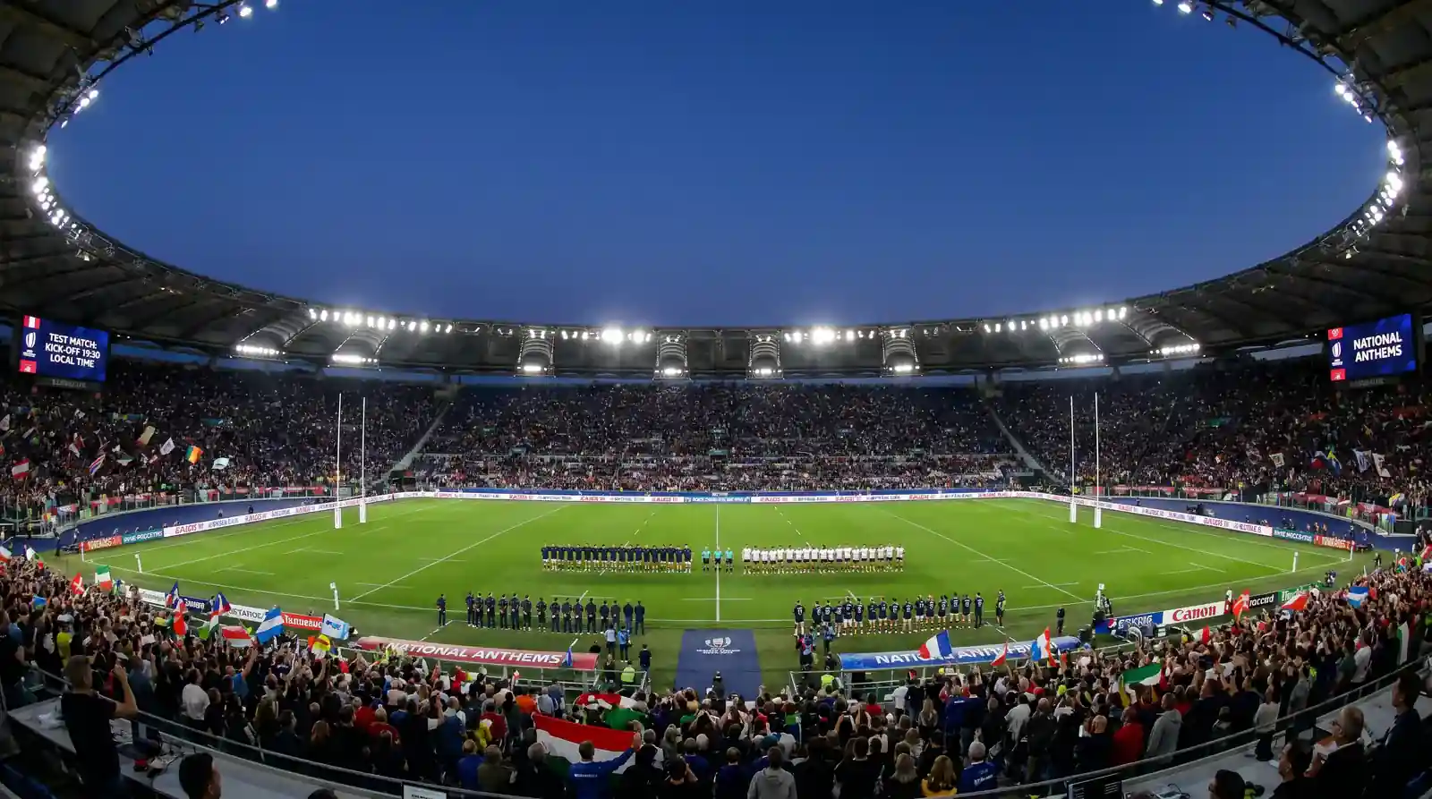 International rugby union test match with two national teams lined up before kick-off under stadium lights