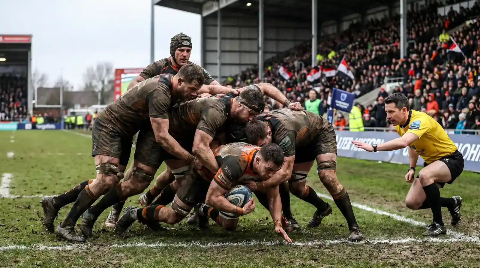 Rugby forwards driving over the line from a maul near the opposition try line